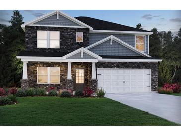Charming two-story home featuring a stone facade, well-manicured lawn, and an attached two-car garage at 4002 Brushy St, Powder Springs, GA 30127