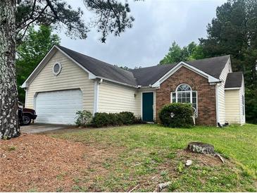 Charming single-Gathering home featuring brick accents, a two-car garage, and a well-maintained lawn at 1237 Summerstone Trce, Austell, GA 30168