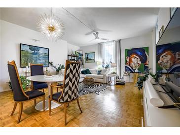 Inviting living room featuring a zebra rug, modern lighting, and an open floor plan perfect for entertaining at 130 26Th Nw St # 701, Atlanta, GA 30309