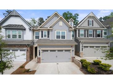 Charming townhomes featuring attached garages and well-maintained exteriors at 1025 Cherryfield Run, Marietta, GA 30008