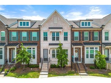 Charming brick townhome with black shutters and landscaped front yard, offering curb appeal at 1172 Edwin Ln, Sugar Hill, GA 30518