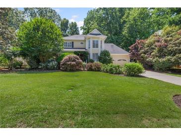 Charming two-story home with a well-manicured lawn and lush landscaping at 3231 Connemara Trce, Lawrenceville, GA 30044