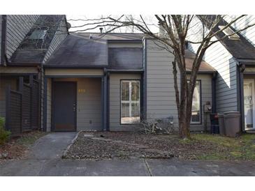 Modest home featuring muted tones, a simple entry, and natural landscaping in a quiet residential neighborhood at 272 Toweridge Dr, Marietta, GA 30064