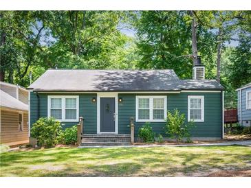 Charming single-story home with green siding, well-maintained lawn, and inviting front entrance at 936 Ormewood Se Ter, Atlanta, GA 30316