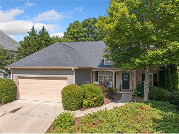 Charming home featuring a two-car garage, landscaped yard, and inviting front entrance at 139 Mountain Vista Blvd, Canton, GA 30115