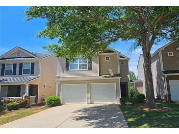 Charming two-story home with a two-car garage and well-maintained front yard at 5465 Mountain Top Pl, Cumming, GA 30041
