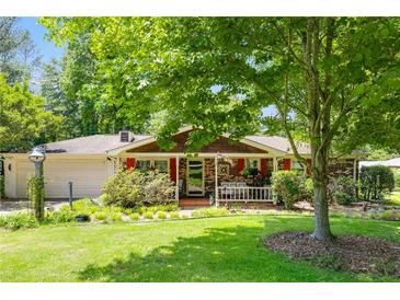 Charming single story home with brick facade, mature landscaping, and a cozy front porch at 4544 Ridgeview Dr, Powder Springs, GA 30127