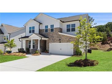 Charming two-story home featuring a stone facade, white siding, and an attached two-car garage at 4011 Fallen Leaf Ct, Kennesaw, GA 30152