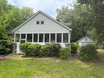 Charming bungalow-style home with a sunroom and detached garage at 602 Hamilton Holmes Dr, Atlanta, GA 30318