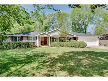 Charming ranch-style home featuring a brick facade, mature landscaping, and a well-maintained front yard at 1448 Diamond Head Cir, Decatur, GA 30033