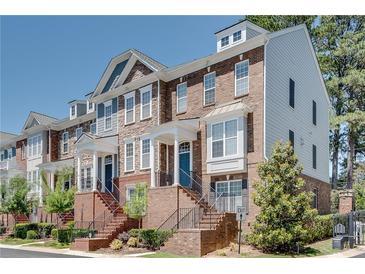 Charming townhome exterior with brick facade, covered entry, and well-maintained landscaping at 2325 Limehurst Ne Dr, Atlanta, GA 30319