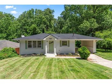 Charming single-story home with a well-manicured lawn and attached carport at 805 Gertrude Nw Pl, Atlanta, GA 30318