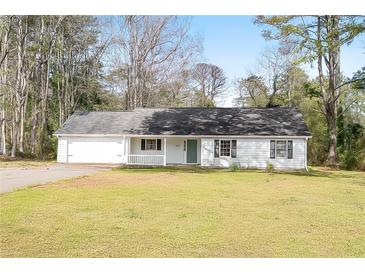 Charming single-story home featuring a welcoming front porch and well-maintained lawn at 2931 Oakwilde Ct, Snellville, GA 30039