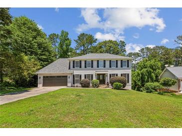 Charming two-story home boasts a well-manicured lawn and a classic design at 3145 Indian Hills Ne Dr, Marietta, GA 30068