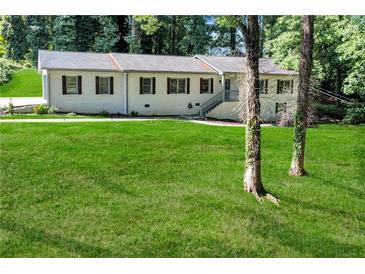 Traditional single-Gathering home showcasing a well-manicured lawn and landscaped front yard at 2418 Bolling Brook Sw Dr, Atlanta, GA 30311