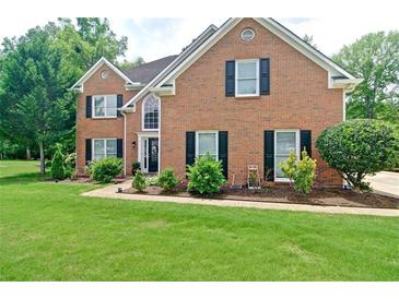 Charming two-story brick home with a well-manicured front yard and classic black shutters at 2420 Westport Cir, Marietta, GA 30064