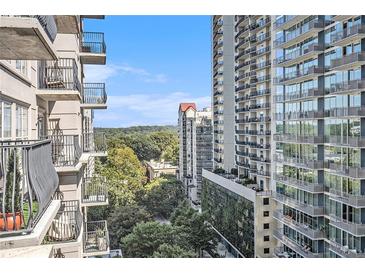 Scenic view from a high rise balcony overlooking the city skyline and lush greenery on a bright day at 195 14Th St # 902, Atlanta, GA 30309