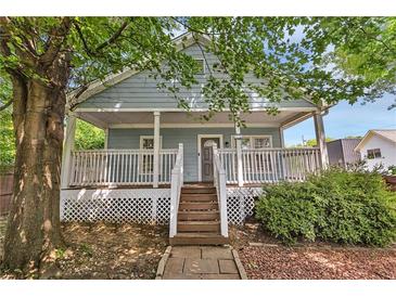 Charming home featuring a large front porch, well-maintained landscaping, and inviting curb appeal at 827 Fraser Se St, Atlanta, GA 30315