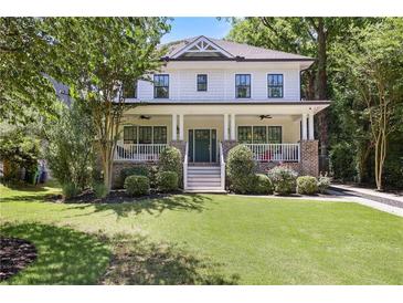 Charming two-story home with a welcoming front porch and lush green lawn at 1297 Conway Rd, Decatur, GA 30030