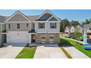 Charming two-story home with a modern exterior design, a well-manicured lawn, and a spacious driveway at 415 Camrose Ave, Union City, GA 30291