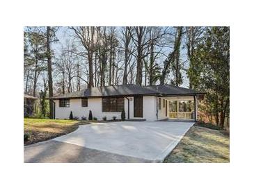 Charming single-story home with a modern painted brick facade and mature trees in a desirable neighborhood at 1120 Starline Se Dr, Smyrna, GA 30080