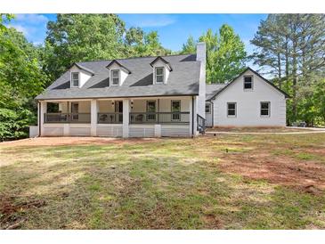 Charming two-story home with dormer windows and a spacious porch at 1143 Mcgarity Rd, Mcdonough, GA 30252