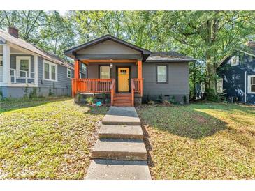 Charming home with a welcoming porch, warm wood accents, and a sunny yellow front door at 1336 Mcclelland Ave, Atlanta, GA 30344