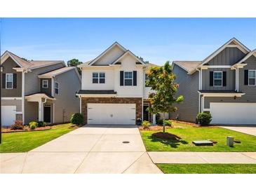Charming two-story home with a well-manicured front yard and a two-car garage at 118 Woodhouse Cir, Acworth, GA 30102