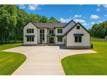 Stunning two-story modern farmhouse with sleek black accents and an expansive front yard at 1604 Greendale Rd, Covington, GA 30014
