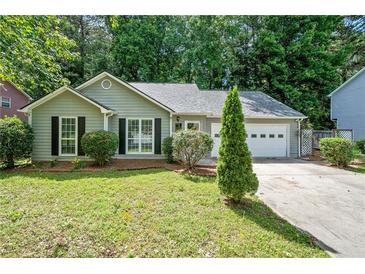 Charming home with attached garage, manicured lawn and mature trees at 4941 Lighthouse Pointe, Acworth, GA 30101