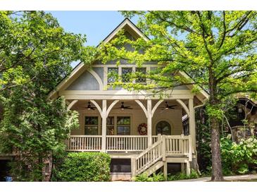 Charming craftsman home with a covered front porch, decorative railings, and lush landscaping creating curb appeal at 980 Faith Se Ave, Atlanta, GA 30316