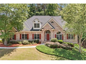 Charming brick home with well-maintained landscaping, red shutters, and inviting curb appeal at 997 Thousand Oaks Nw Bnd, Kennesaw, GA 30152
