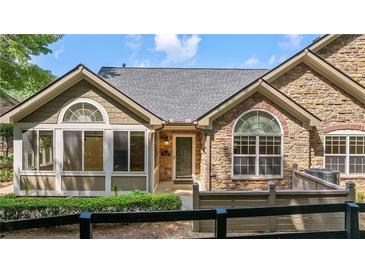 Charming home featuring a stone and siding facade, complemented by well-manicured landscaping at 5336 Stone Village Nw Cir # 2, Kennesaw, GA 30152
