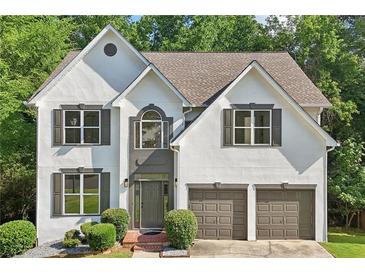 Charming two-story stucco home with a well-manicured lawn and attached two-car garage at 1097 Soaring Way, Marietta, GA 30062