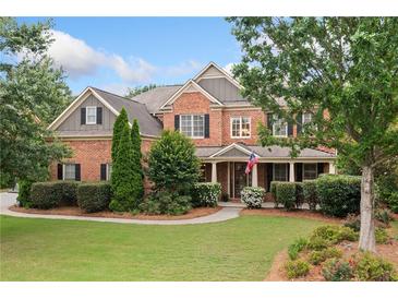 Charming two-story brick home with a well-manicured lawn and inviting front porch at 910 Ovalene Sw Ln, Marietta, GA 30064
