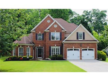 Beautiful two-story brick home featuring a well-manicured lawn and a two-car garage at 2940 Saddlebrook Glen Dr, Cumming, GA 30041