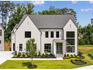 Stunning two-story home featuring a modern design, manicured lawn, and beautiful landscaping at 225 River Valley Ct, Atlanta, GA 30328