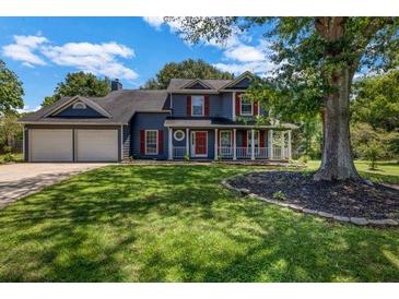 Charming two-story home featuring a well-manicured front yard and a cozy front porch at 2505 Tiffany Se Ct, Conyers, GA 30013