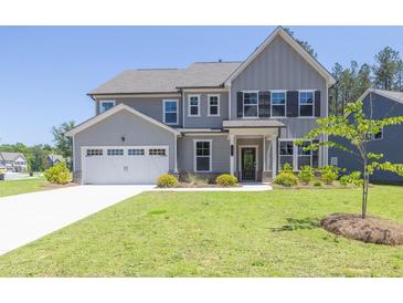 Charming two-story home with a well-manicured lawn and a two-car garage at 8 Foothills Trl, Sharpsburg, GA 30277