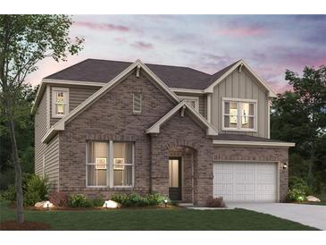 Charming two-story brick home featuring a manicured lawn and attached two-car garage at 7205 Brushwood Bend (Lot 31), Lithonia, GA 30058