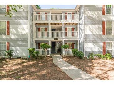 Apartment building exterior featuring multiple balconies, red shutters, and landscaped surroundings at 215 Cobblestone Trl, Avondale Estates, GA 30002