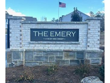 Starlight Homes community, The Emery, featuring a brick sign and an American flag at 305 Winston Way, Villa Rica, GA 30180