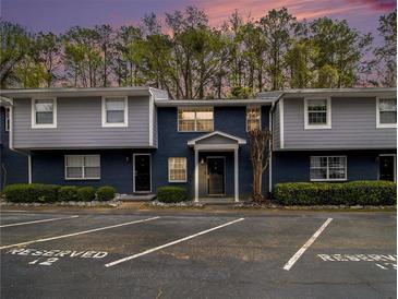 Two-story condo building with reserved parking spaces and a combination brick and siding facade at 3149 Buford Hwy # 3, Brookhaven, GA 30329