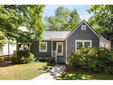 Charming bungalow-style house with gray siding, white trim, and a well-maintained front yard with mature trees and walkway at 1367 Ormewood Se Ave, Atlanta, GA 30316