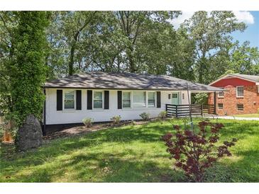 Charming single-story home with white brick, dark shutters, and a well-manicured lawn at 623 Montevista Sw St, Atlanta, GA 30310