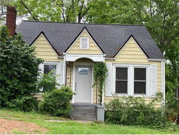 Charming yellow house with white trim, gabled roof, chimney, and welcoming front porch at 1238 Trenton St, Atlanta, GA 30316