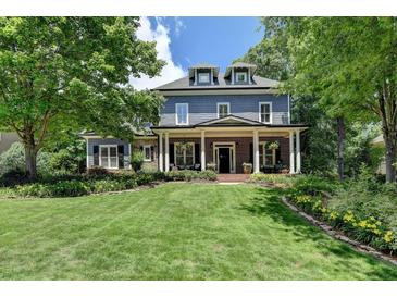 Charming two-story home with manicured lawn, complemented by lush landscaping and mature trees at 3715 Horizon Ct, Cumming, GA 30041