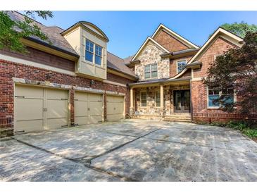 Stunning two-story home featuring a brick and stone exterior with a three-car garage at 3333 N Hembree Rd, Marietta, GA 30062