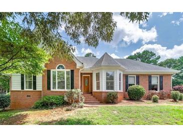 Charming brick home with manicured lawn, mature trees and traditional architectural details at 98 Country Acres Ct, Mcdonough, GA 30253