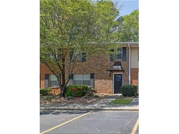 A charming brick townhouse featuring a quaint entrance and well-maintained landscaping at 191 Northdale Pl, Lawrenceville, GA 30046